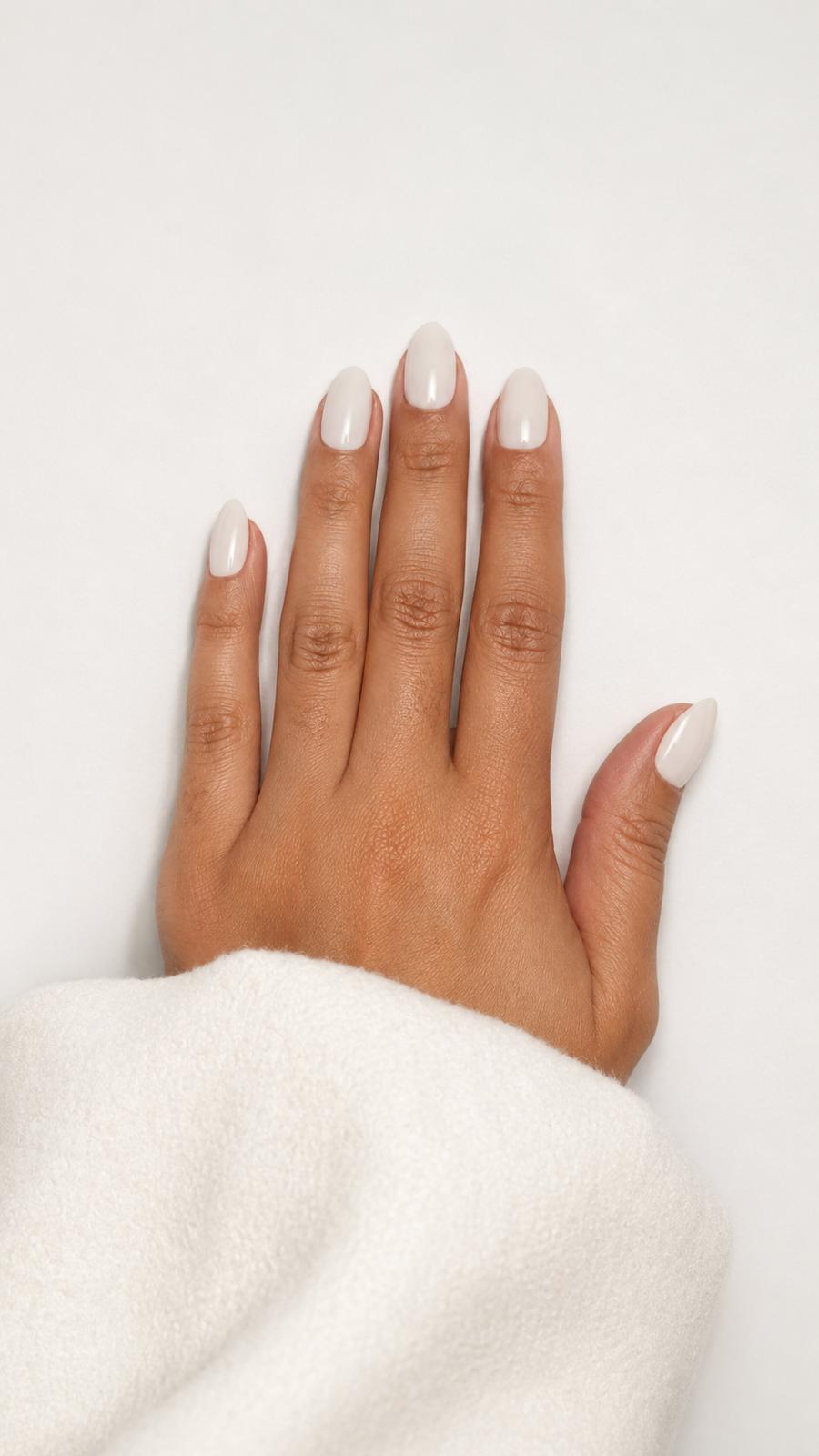Coco press-on nails with a milky white and coconut finish, short almond.
