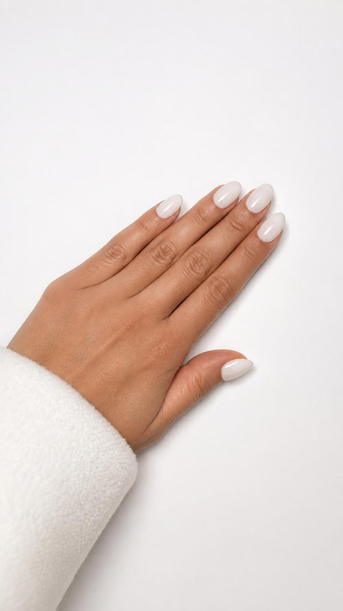 Coco press-on nails with a milky white and coconut finish, short almond.